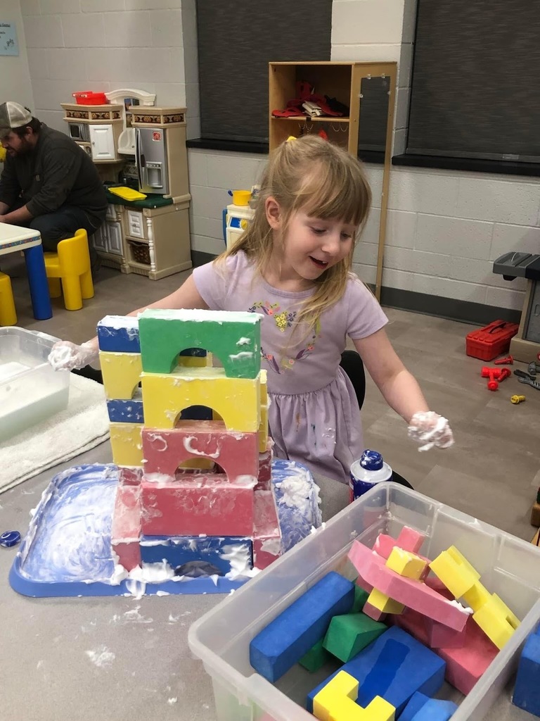 girl playing with blocks and shaving cream