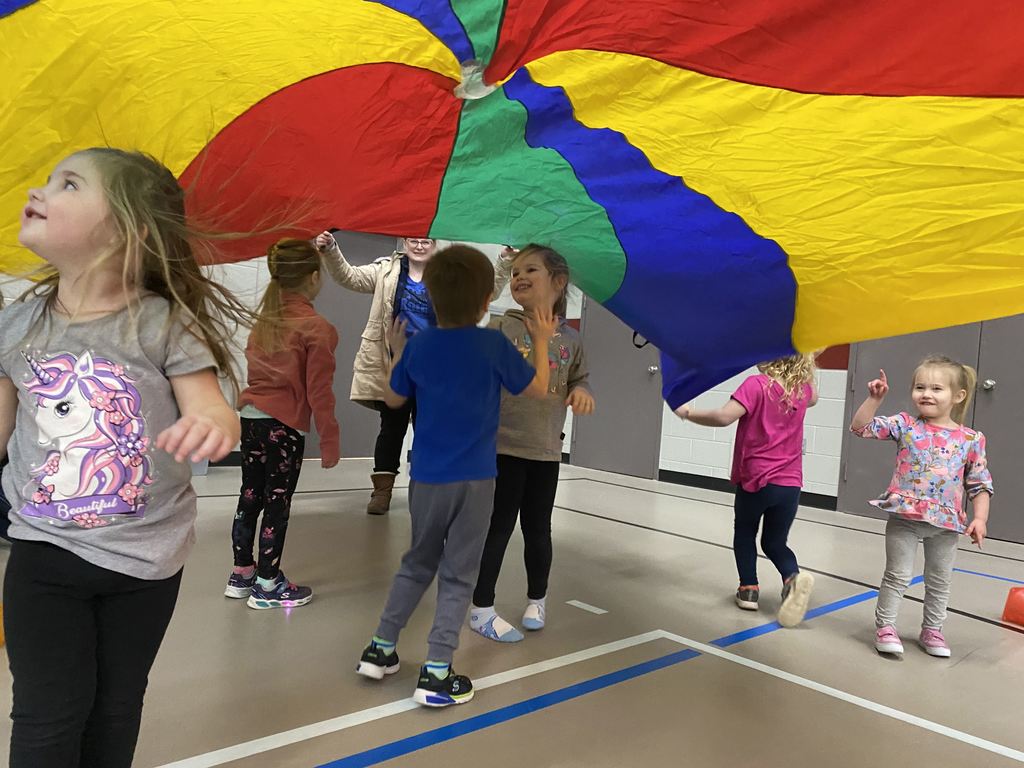 group of children playing with a parachute