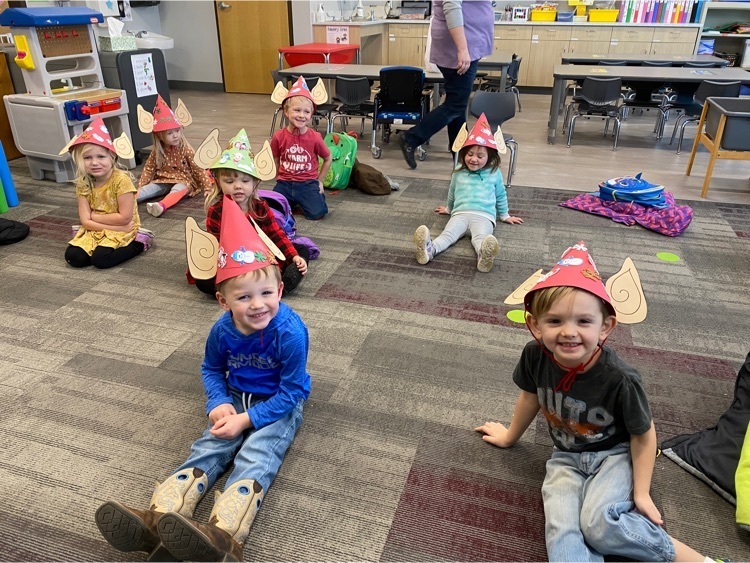 children in classroom wearing elf hats