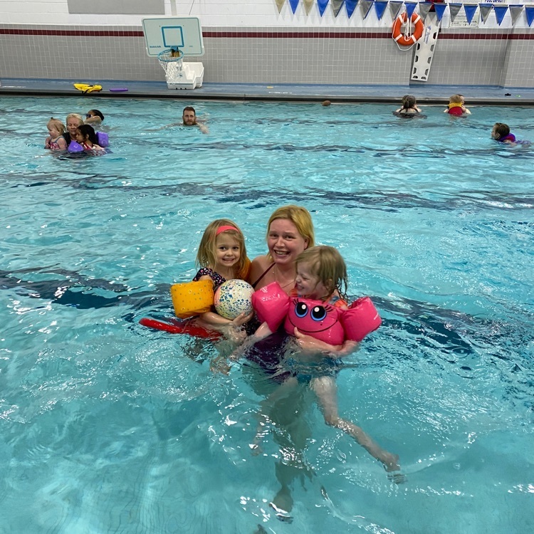 mom swimming with twin daughters  